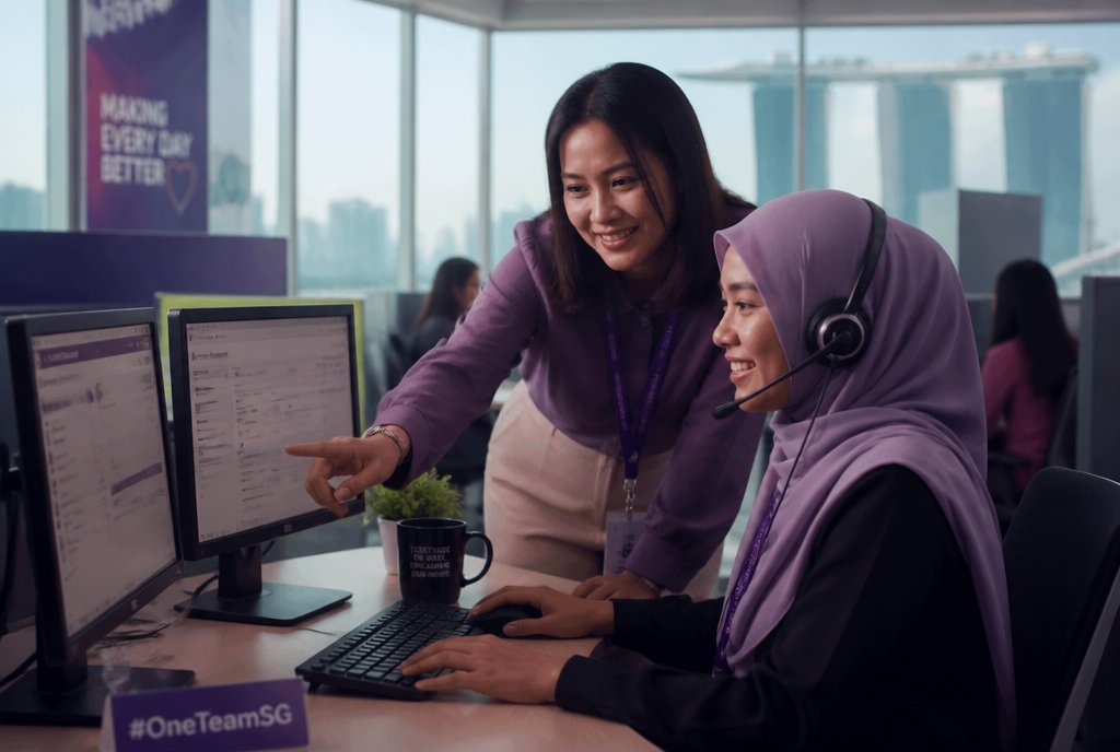A Connect Centre mentor coaching an agent at her call-centre workstation