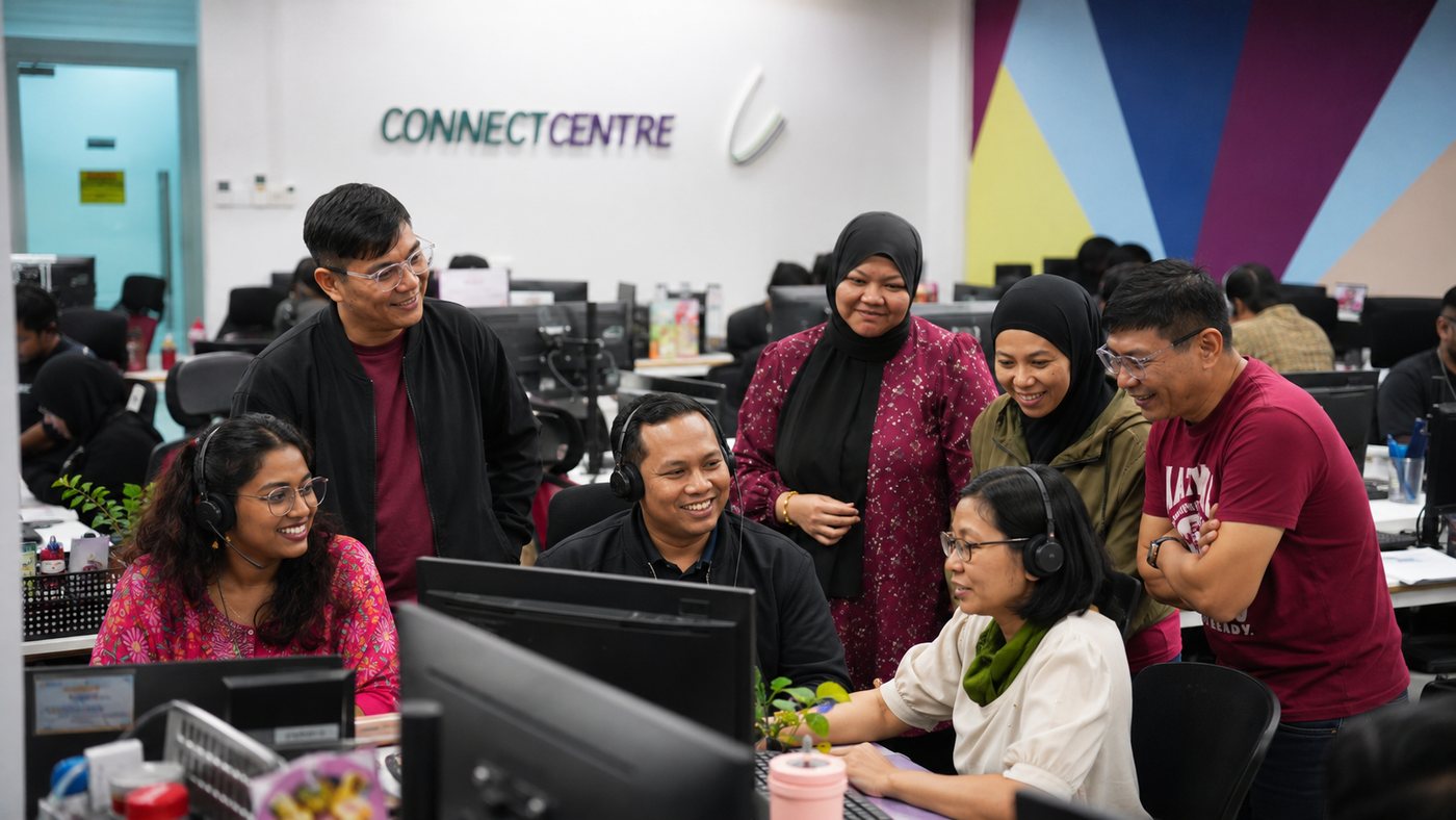 The Connect Centre team gathered around a screen beneath the Connect Centre logo